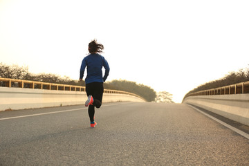 Fototapeta na wymiar young woman runner athlete running at road