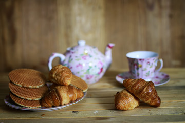 cup croissant breakfast wooden background