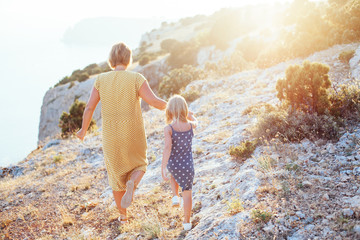 Mom walking with child in sunlight