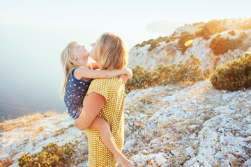 Mom playing with child in sunlight