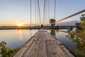 Man on a suspension bridge