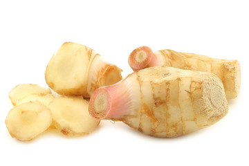 pieces of galangal herb (Siamese ginger) on a white background