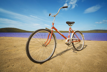 Fototapeta na wymiar Old-fashioned bicycle on summer beach