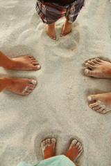 Fototapeta na wymiar Family feet on the sand