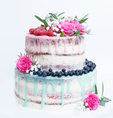 wedding color drip cake with roses, blueberries and  raspberries
