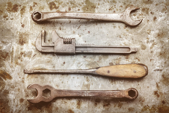 Old work tools on a metal background