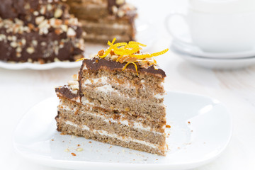 piece of cake with chocolate cream and nuts on a plate