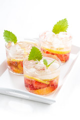 refreshing lemonade with strawberry and lemon on tray, vertical