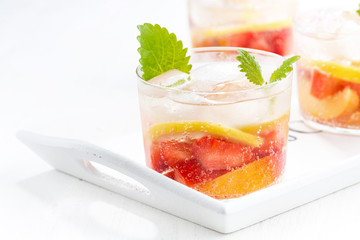 refreshing lemonade with strawberry and lemon on white tray