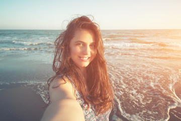 Fototapeta na wymiar The Woman Taking Selfie on the Beach