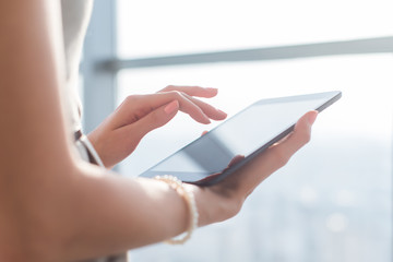 Woman using pda applications with wi-fi internet, touching screen, browsing information, close-up picture.