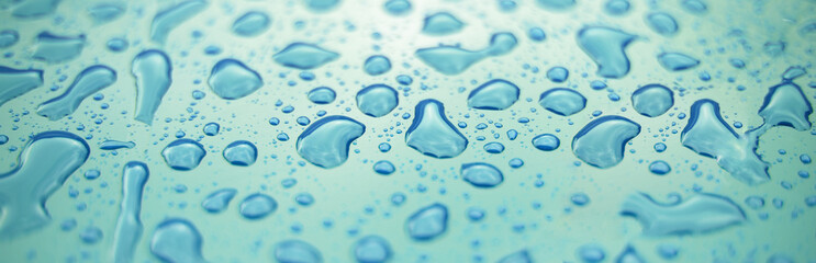 Water drops on surface of blue plastic