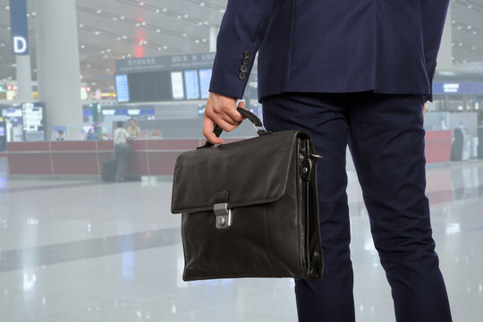  Businessman with a briefcase in airport