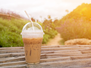 Iced coffee with straw in plastic cup with corlor filter