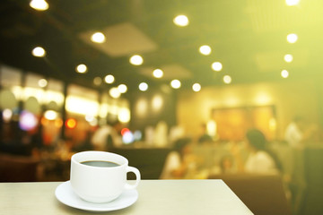 Blurred background : white cup of coffee and customer at restaur