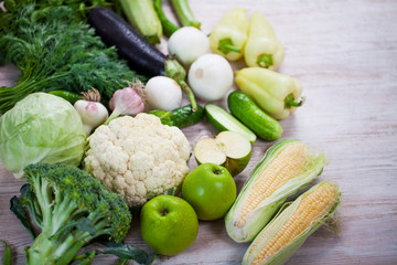 Close up view of collection of fresh green vegetables on white r