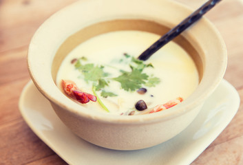 bowl of creamy soup with shrimps on table