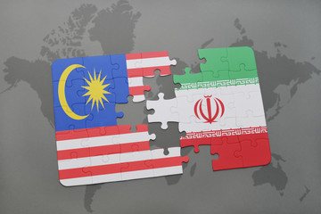 puzzle with the national flag of malaysia and iran on a world map background.