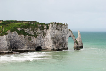 A large arch in the rock on the coast of Etretat in France.