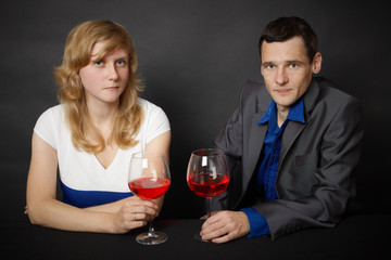 Man and woman drinking red wine at table