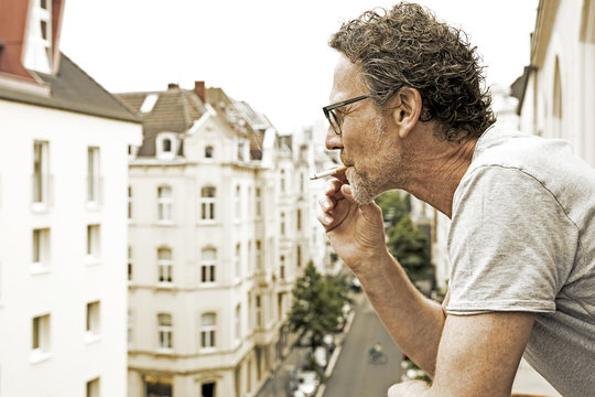 Man smoking on balcony