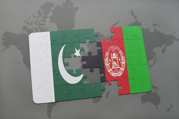 puzzle with the national flag of pakistan and afghanistan on a world map background.