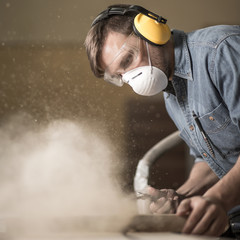 Carpenter using electric saw