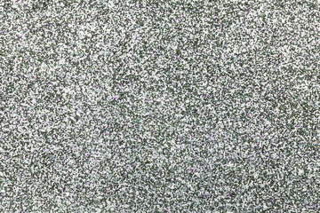 Sparkling background of silver sparkles closeup.