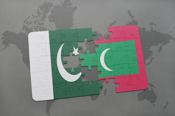 puzzle with the national flag of pakistan and maldives on a world map background.