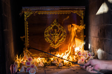 The Buddhist Thai cremation chamber and hand of undertaker
