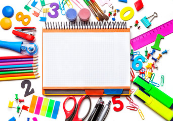 Various school supplies isolated on white background. Notebook in the center of the frame Concept back to school