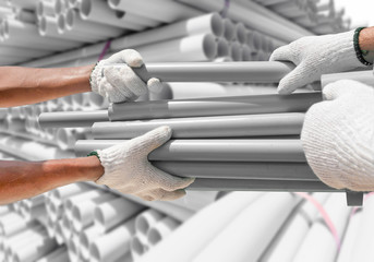 Plumber choose PVC pipes from bundle