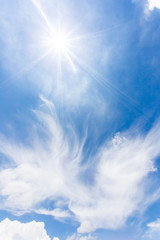 Naklejka na ściany i meble Blue sky background with clouds and sunlight