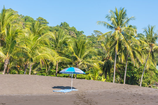 Beach umbrella and towel at playa hermosa en Costa Rica - pacific coast