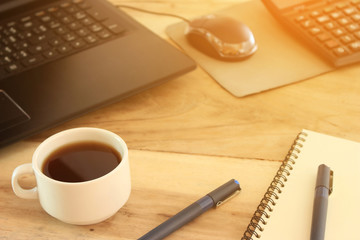 coffee cup and office desk with laptop computer