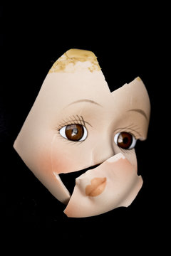 Broken Doll Face and Head on Black Background