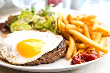 Egg and fries - classical english breakfast with egg and fries