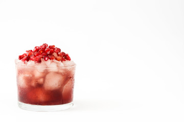 Red cocktail with pomegranate and ice isolated on white background

