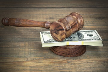 Judges or Auctioneer Gavel And Dollars Cash On  Wooden Table