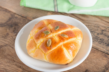 Pumpkin bun topping with pumpkin seeds.