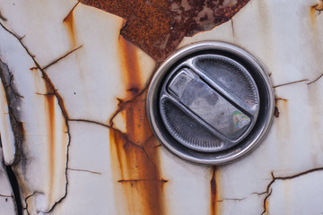 close up of cover on a very old car with rusted 