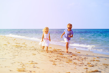 little boy and girl running at beach