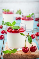 homemade dessert panna cotta with cherry and mint