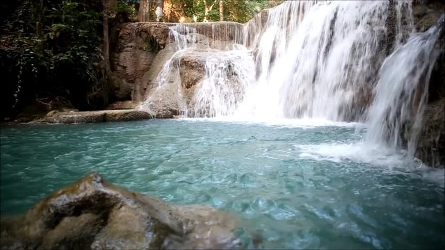 Paradise jungle forest with beautiful waterfall  in Kanchanaburi, Thailand. Emerald pond and exotic plants