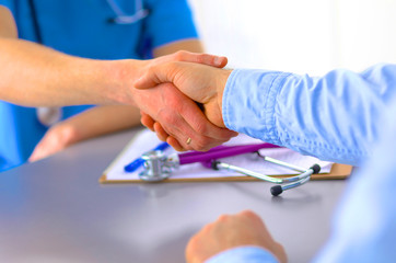 close up of patient and doctor taking notes