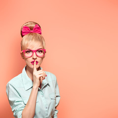 Fashion. Woman in Stylish Glasses Having Fun. Hipster fashion girl think, idea. Playful nerd Blonde...