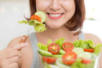 close-up of woman eating fresh salad