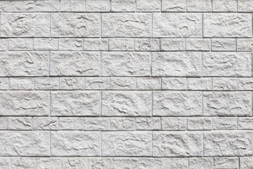 Wall of white bricks and large blocks.