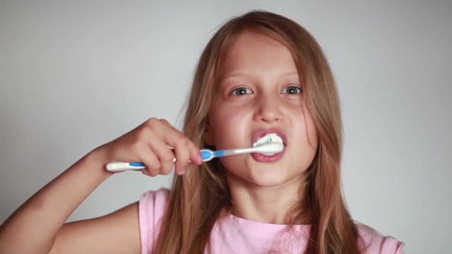 Girl brushing her teeth