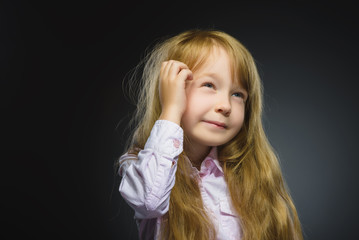 Closeup Thoughtful girl with Hand at head isolated on Gray